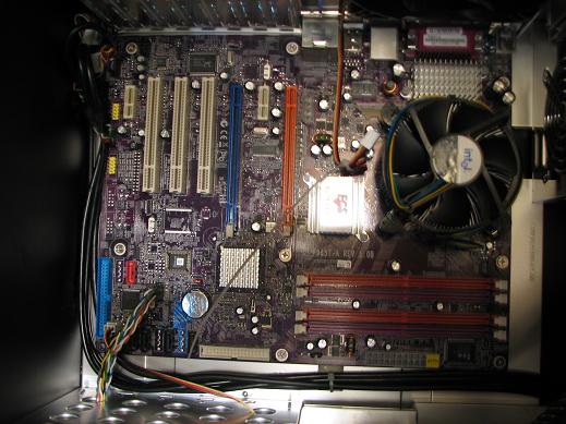Put The Heat sink (With Thermal Grease) Into Place Over The CPU And Carefully Push The Plastic Pins Into Place And Turn To Lock